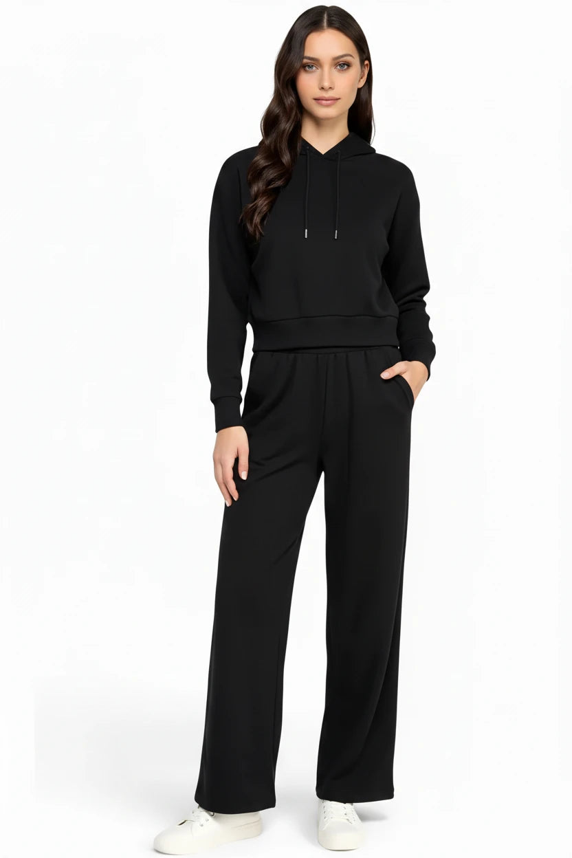 Women modeling a black relaxed-fit hoodie and straight leg pants lounge set.