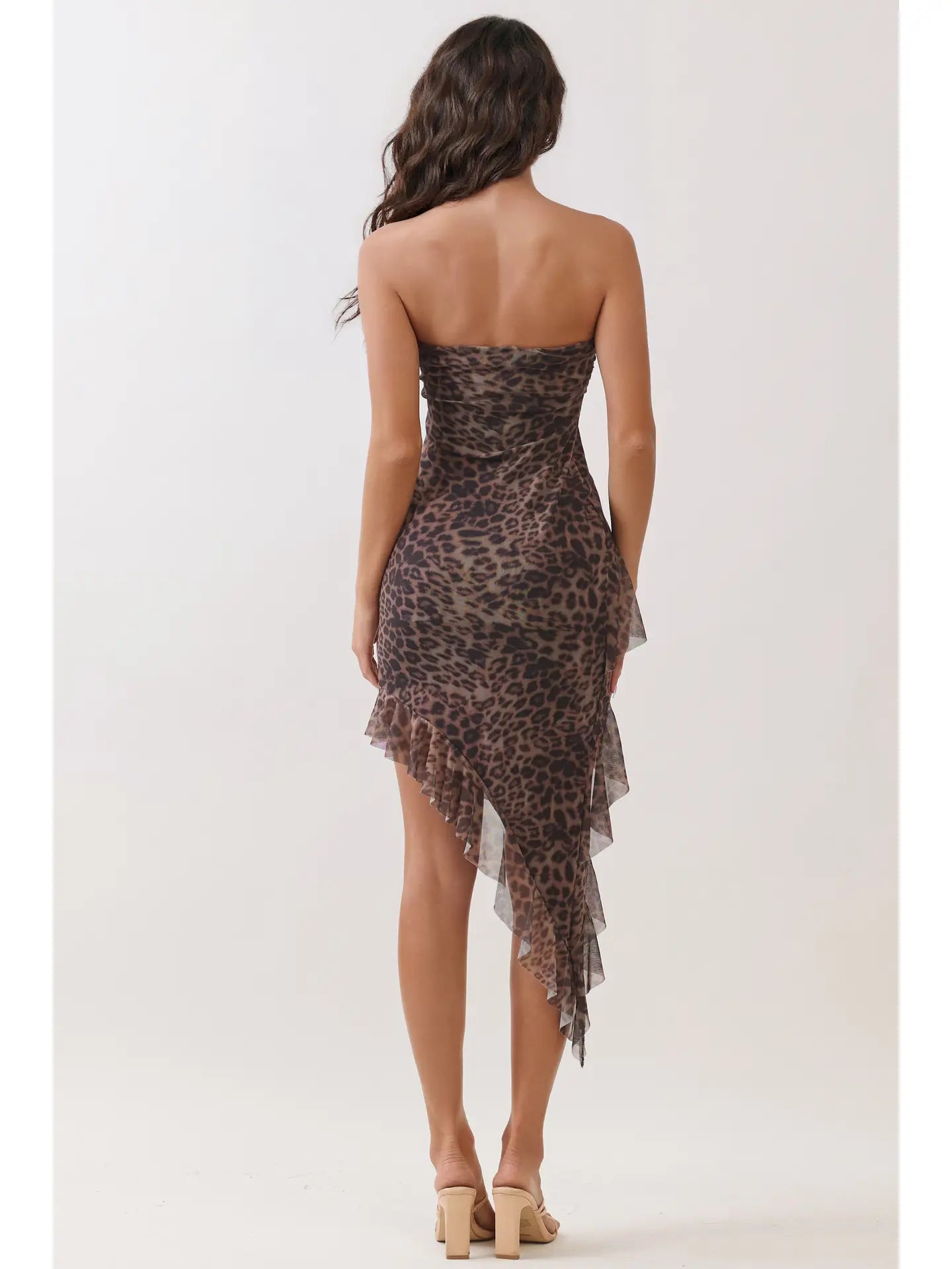 back view of strapless leopard bodycon dress with asymmetrical hem and fitted silhouette.
