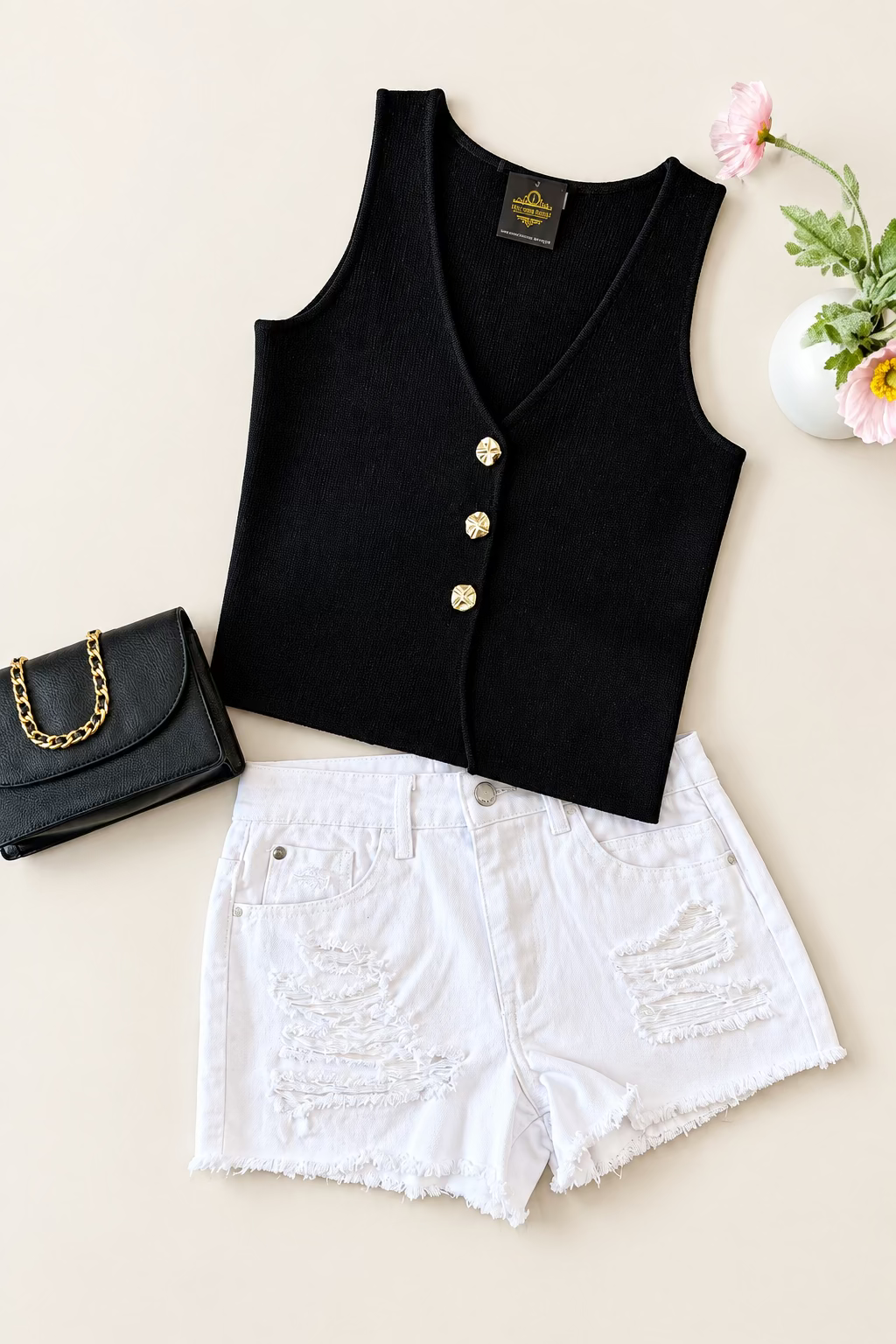 Kateline black button-front vest top styled with white distressed denim shorts and black handbag