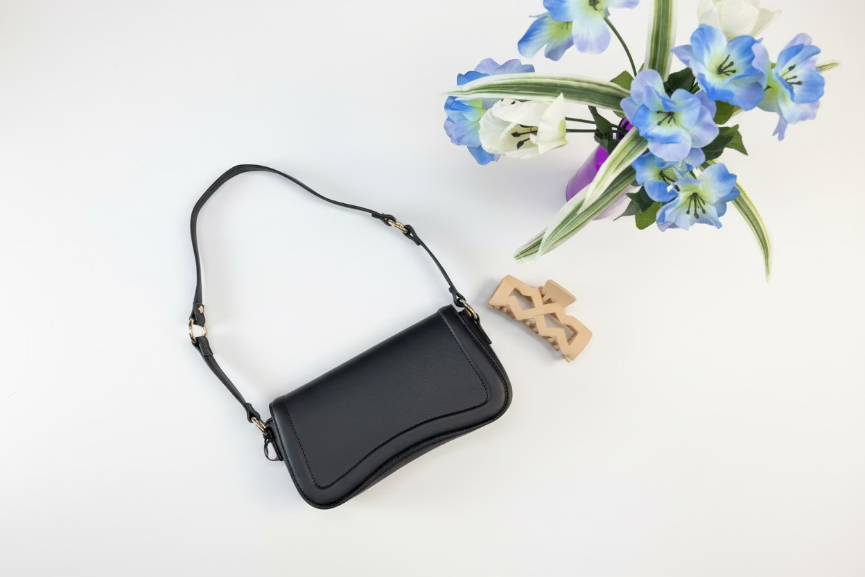 Black noir curve shoulder bag with gold hardware from women's boutique. Lily's Fashion Boutique