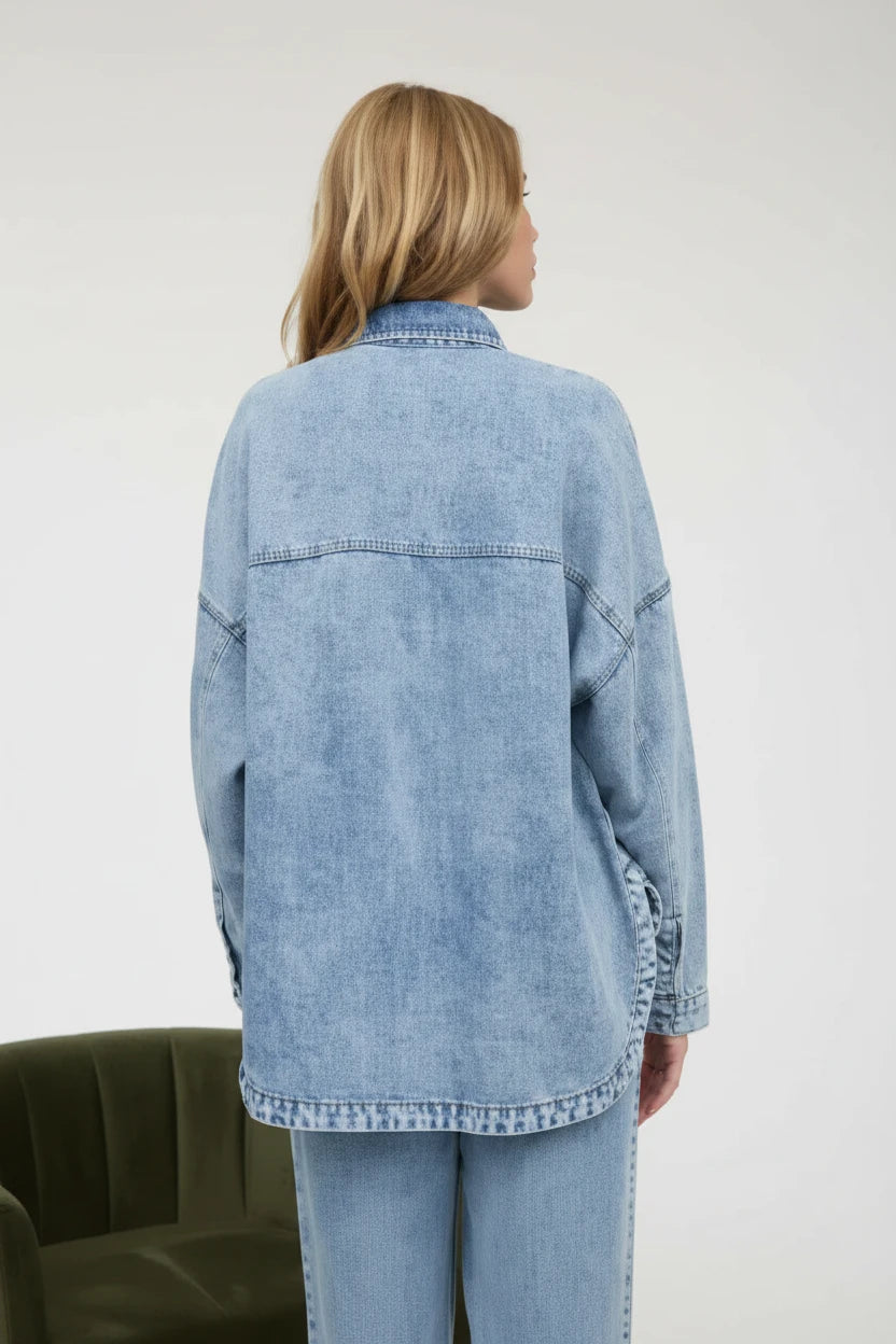 Back of oversized denim top, with light wash jeans.