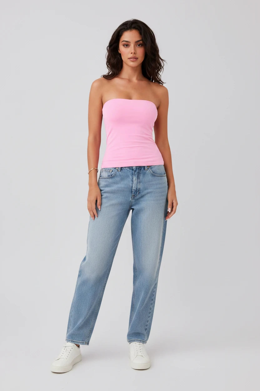 Women's pink strapless tube top with built-in bra, styled with light wash relaxed-fit jeans and white sneakers. A flattering fitted top perfect for summer outfits, casual wear, vacations, concerts, and layering. Comfortable, stretchy, and true to size.