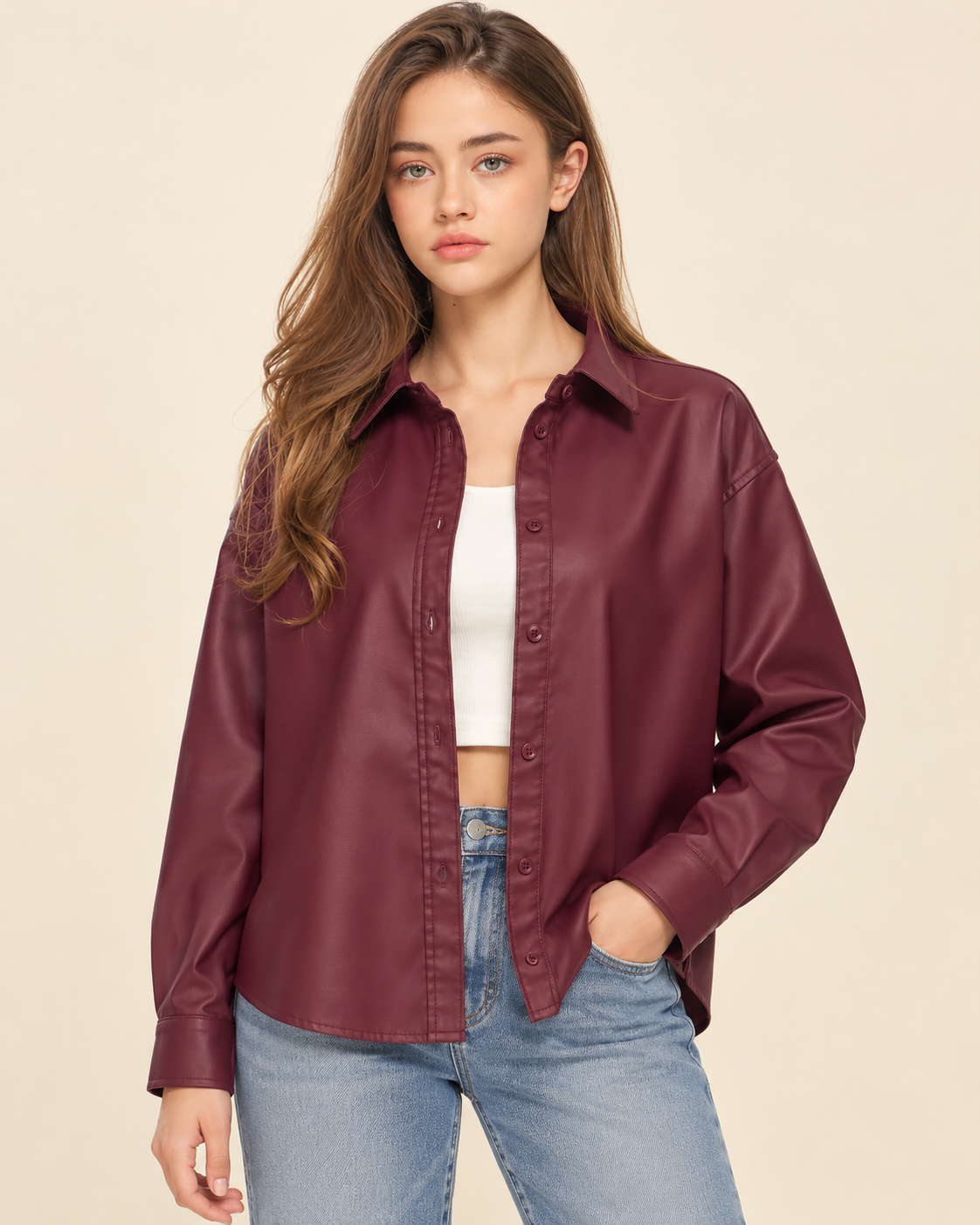 model wearing  a burgundy button-up blouse over s white top.