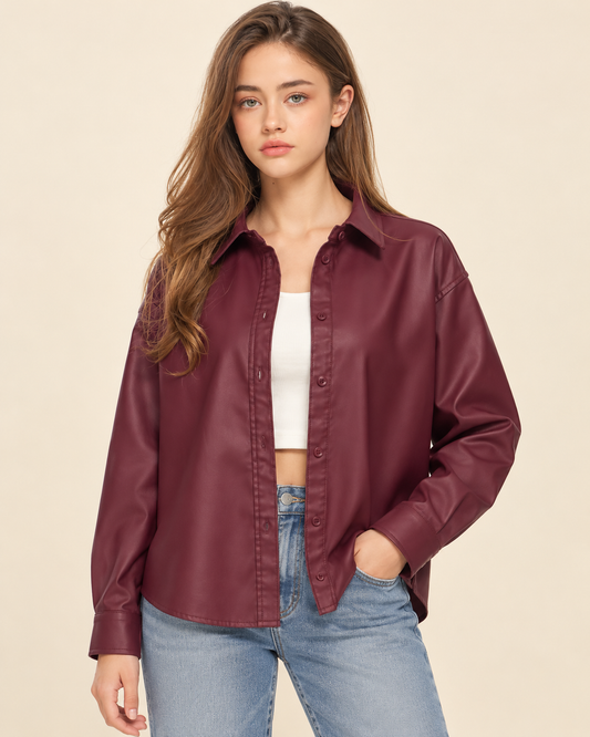 model wearing  a burgundy button-up blouse over s white top.