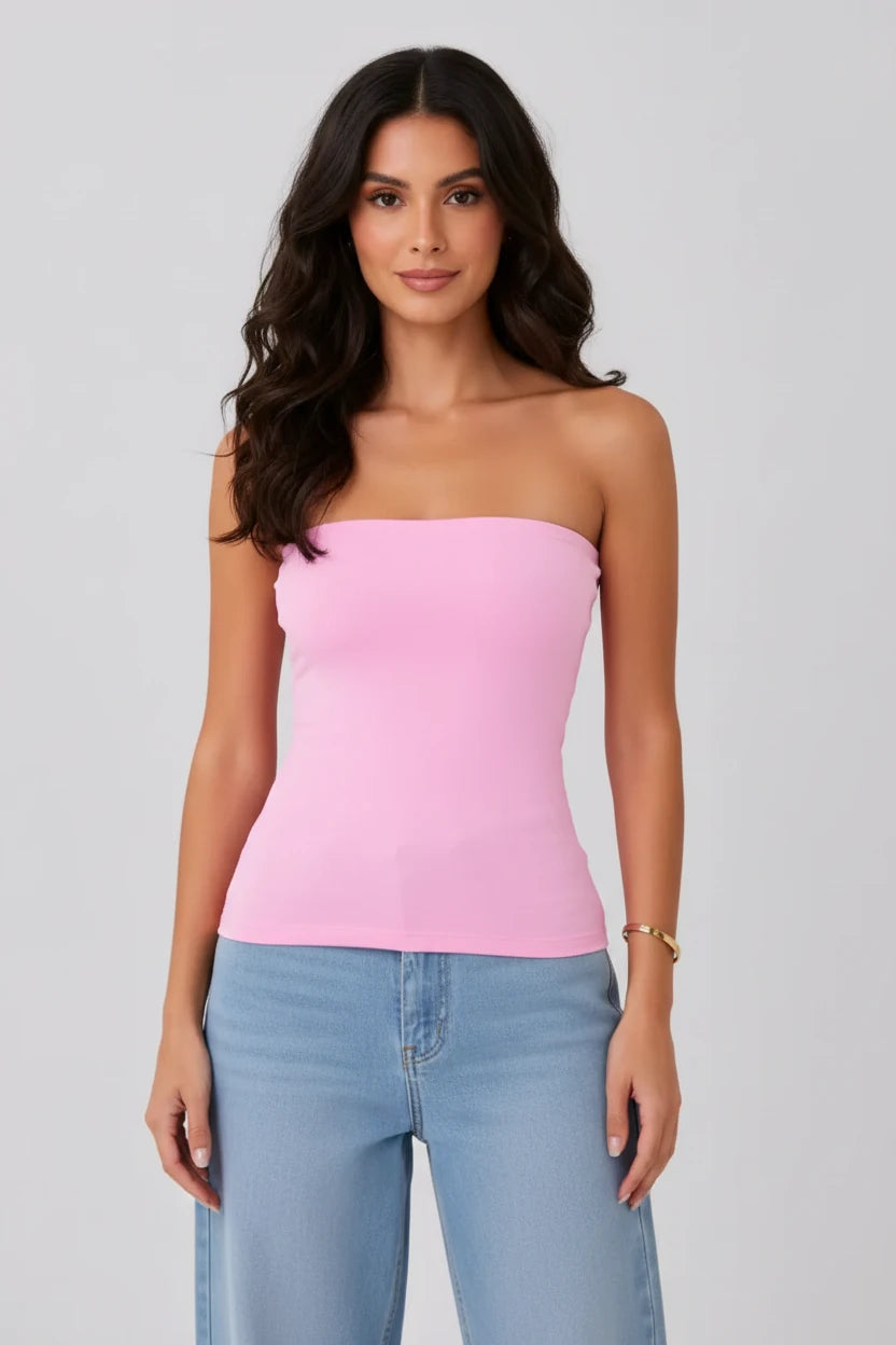 Women's pink strapless tube top with built-in bra, styled with light wash relaxed-fit jeans. A flattering fitted top perfect for summer outfits, casual wear, vacation wear.
