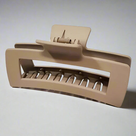 Beige hair clip on a marble surface