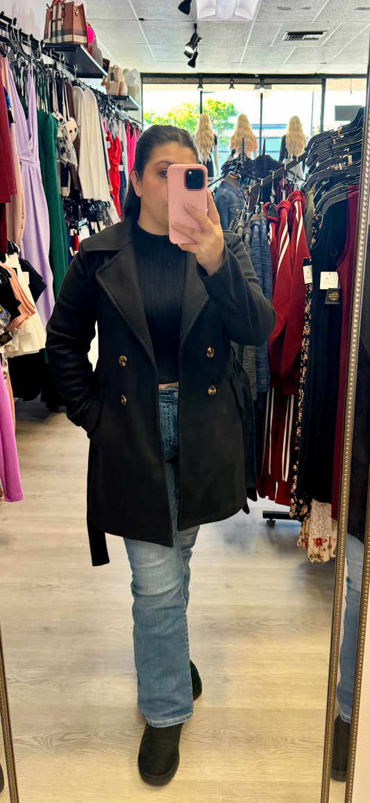 Women's black trench coat with collared neckline and front lapel.