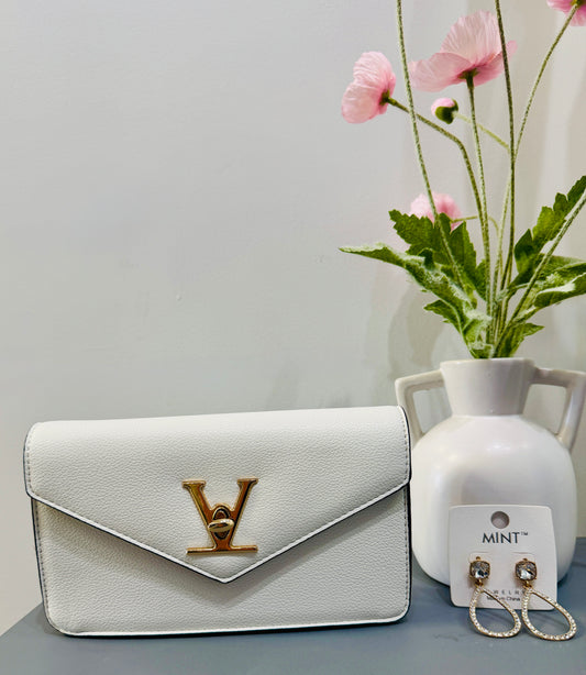 Celine Purse White- gold strap with gold details. 
Outing and holiday perfect. Shop Lily's Fashion Boutique.