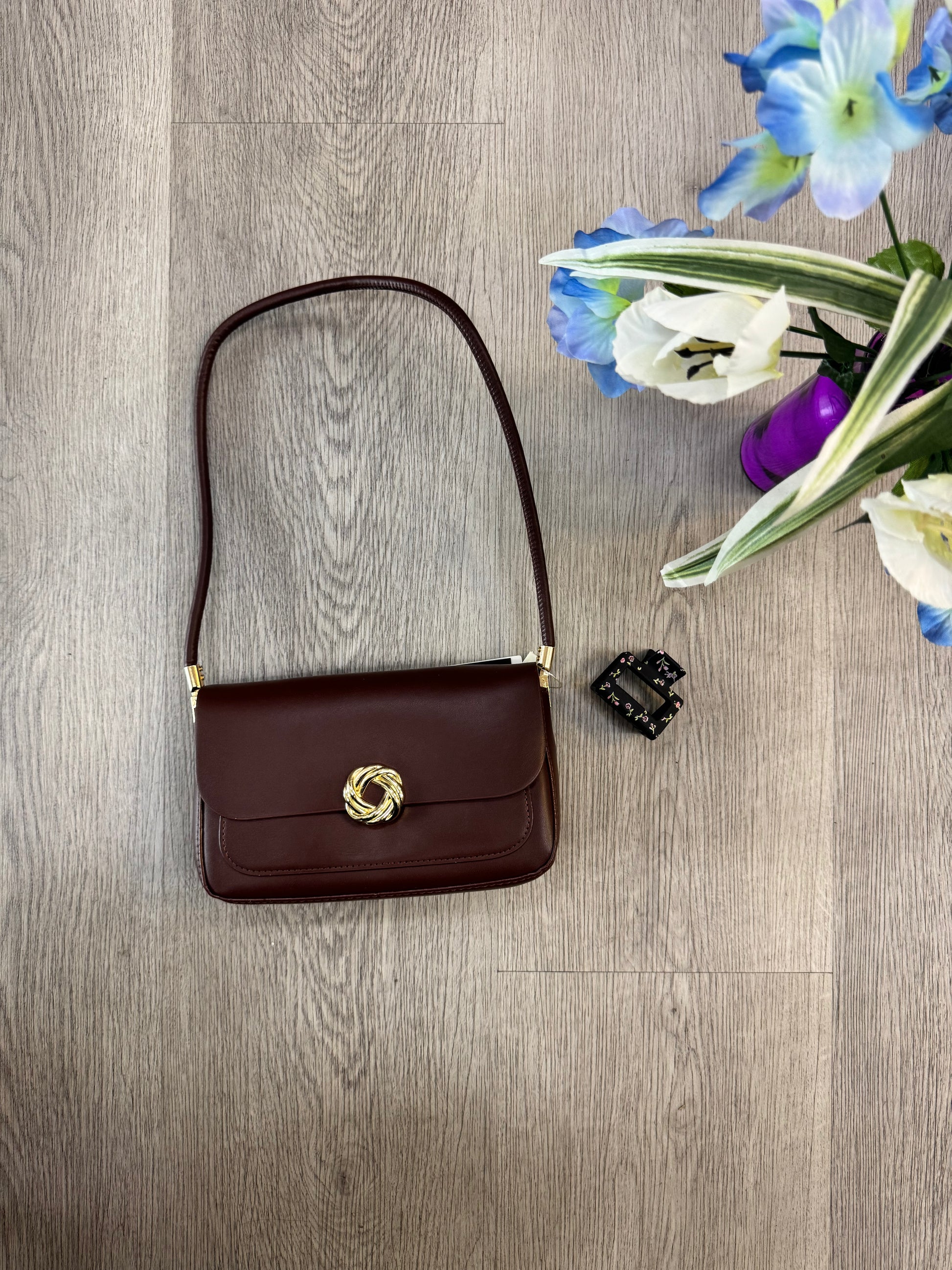 Isabelle knot shoulder bag with gold magnetic closure from women's boutique.