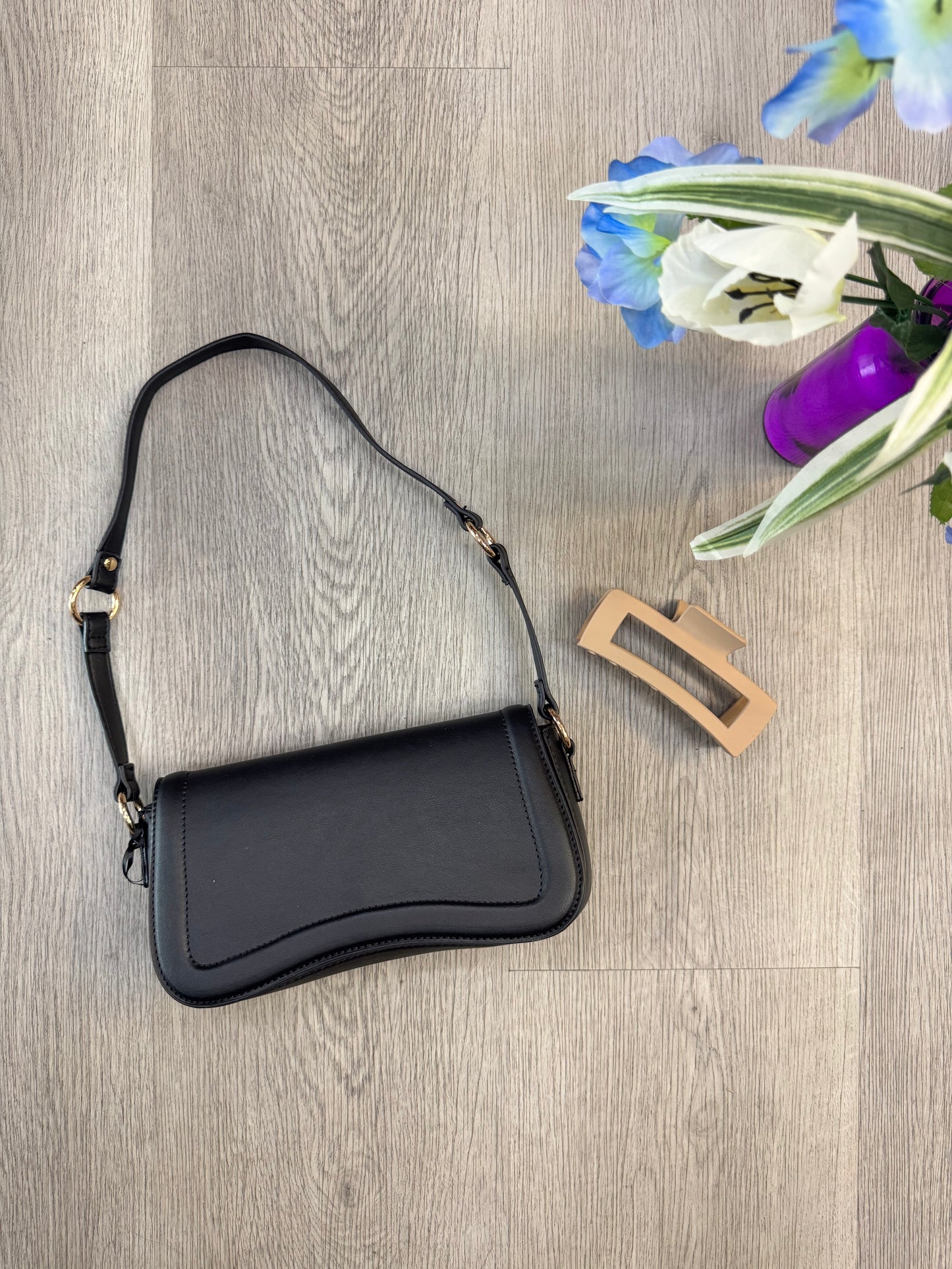 Black noir curve shoulder bag with gold hardware from women's boutique. Lily's Fashion Boutique