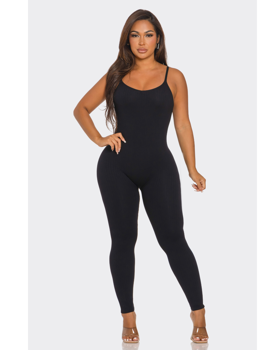 Woman wearing a black jumpsuit on a white background
